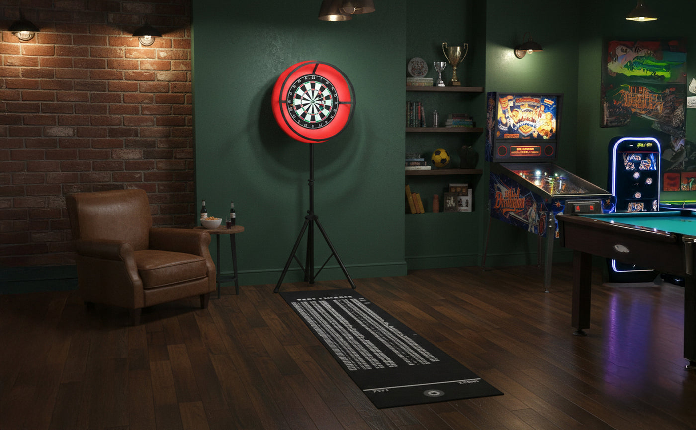 En mysig spelhörna med en darttavla i röd ram, en läderfåtölj, biljardbord och retro spelmaskin på mörkt trägolv