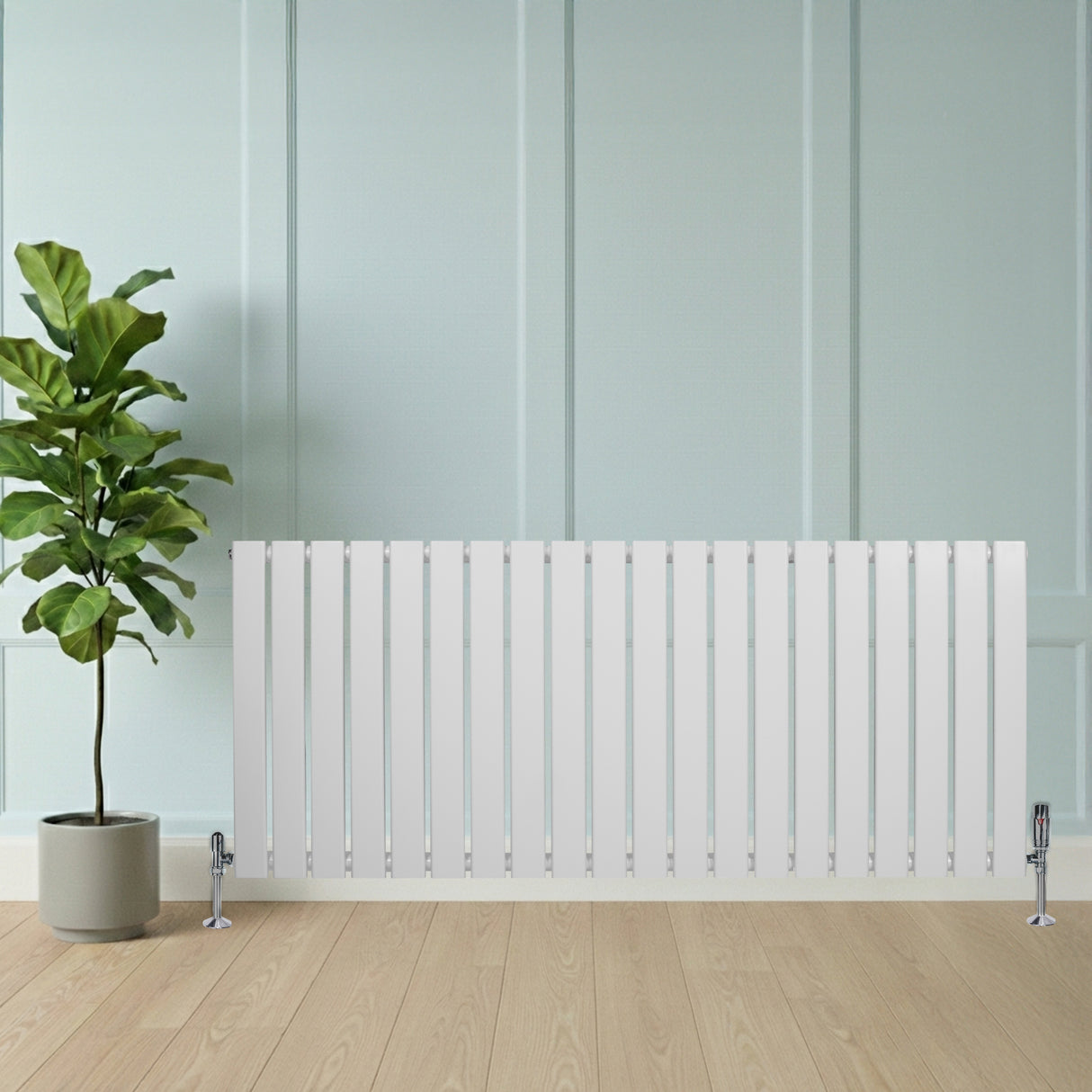 Platt vit enkelkolumnsradiator med ventiler, 600 mm x 1400 mm, placerad framför en grön växt i en modern inredning