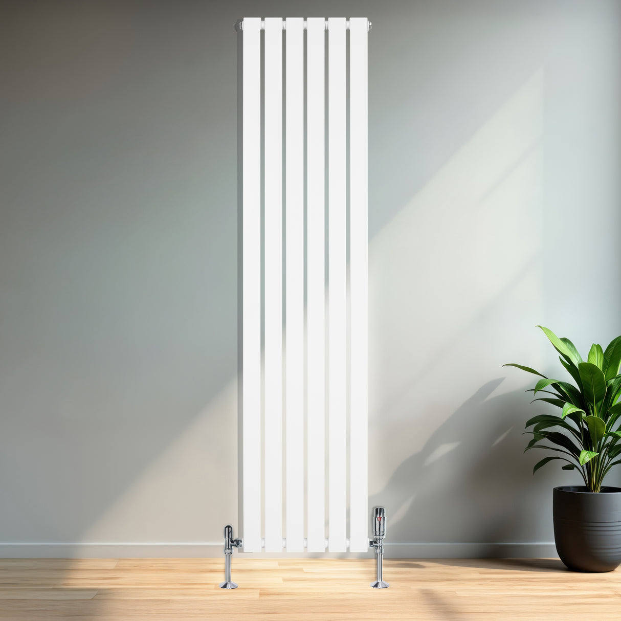 Platt enkelkolumnsradiator i vitt, 1800 mm x 420 mm, med ventiler, placerad mot en vägg i ett ljust rum med trägolv och växt